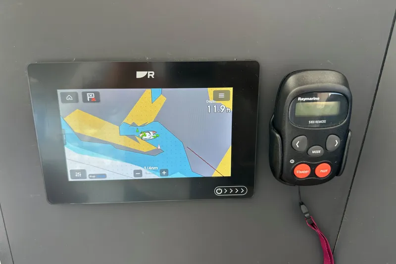 Slide: The Image of Navigation display and remote control on a 2023 Bali 4.4 yacht dashboard. - 63