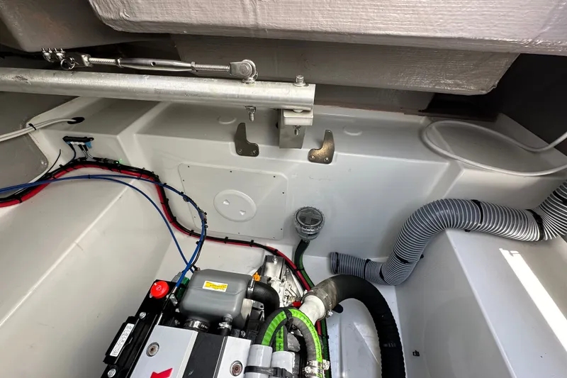 Slide: The Image of Engine compartment of 2023 Bali 4.4 model, showcasing wiring and ventilation hoses. - 112