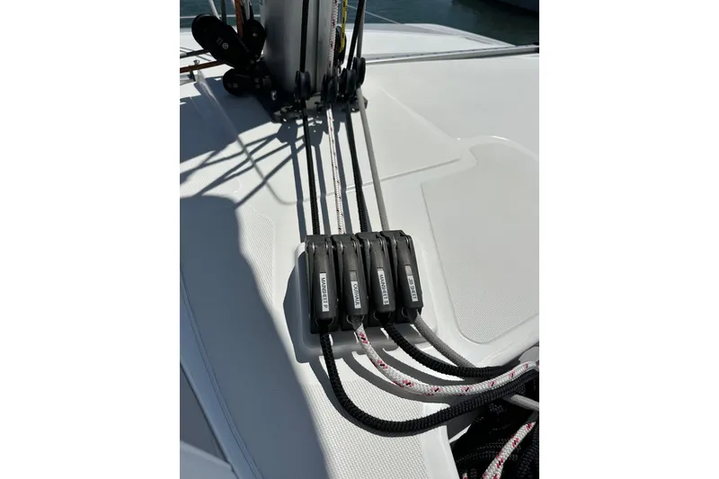 Slide: The Image of Sailing rigging on 2023 Bali 4.4 yacht deck, featuring labeled rope clutches. - 43