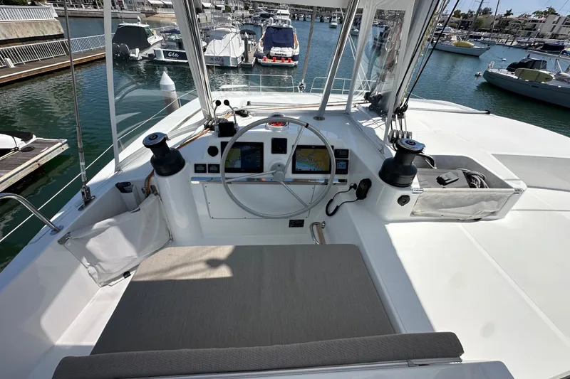 Slide: The Image of Helm of 2023 Bali 4.4 yacht with navigation screens, docked in marina. - 35