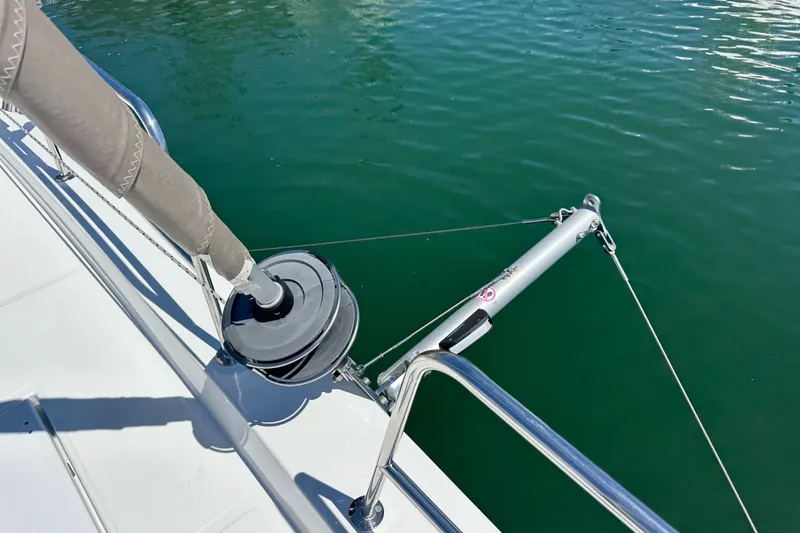 Slide: The Image of Bali 4.4 sailboat deck detail, 2023 model, featuring rigging and calm water. - 23