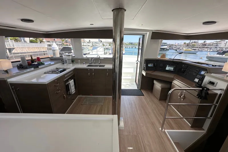 Slide: The Image of Modern 2023 Bali 4.4 yacht interior with kitchen and helm, overlooking marina. - 56