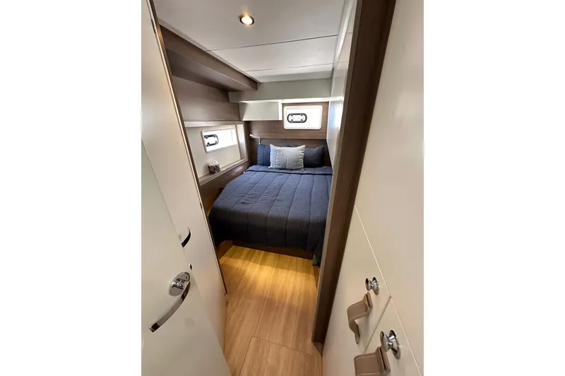 Slide: The Image of Cozy cabin interior of 2023 Bali 4.4 yacht with bed and porthole windows. - 96