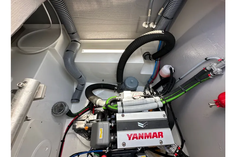 Slide: The Image of Engine compartment of a 2023 Bali 4.4 yacht with Yanmar engine and hoses. - 111