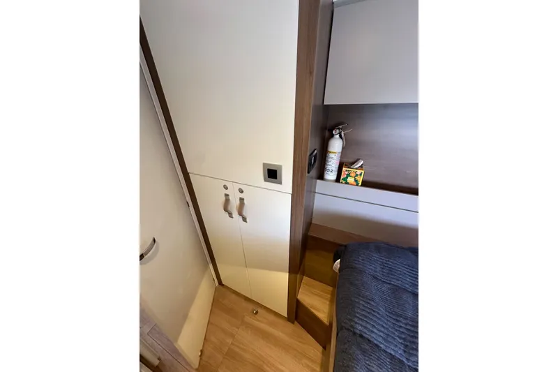 Slide: The Image of Interior of 2023 Bali 4.4 yacht cabin with storage and fire extinguisher. - 92