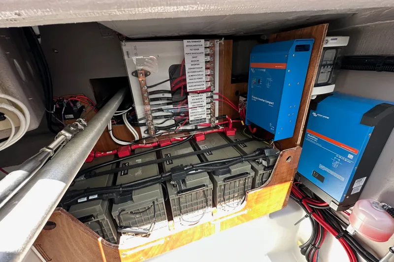 Slide: The Image of Electrical system setup in a 2023 Bali 4.4, featuring batteries and inverters. - 104