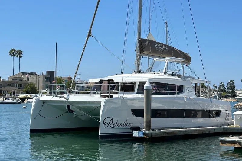 The Image of 2023 Bali 4.4 catamaran docked in a marina, clear blue sky background. - 1