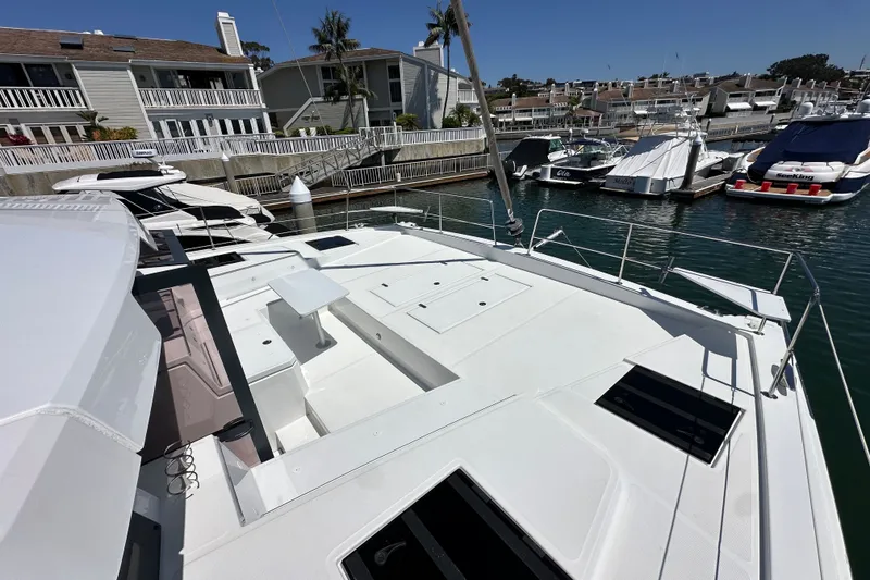 Slide: The Image of Modern 2023 Bali 4.4 yacht docked at marina, showcasing spacious deck and sleek design. - 22