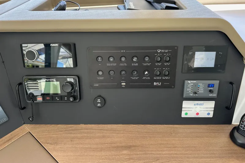 Slide: The Image of Control panel of a 2023 Bali 4.4 yacht with navigation and audio systems. - 65