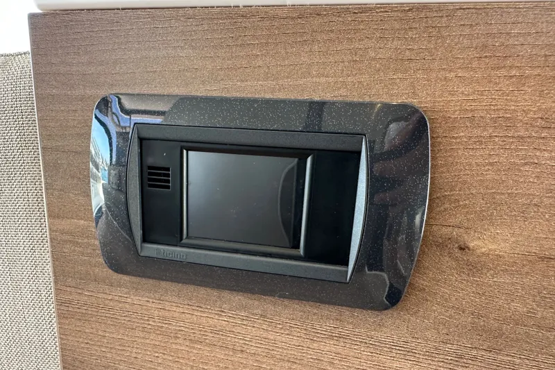 Slide: The Image of Wall-mounted black switch panel on wooden surface, Bali 4.4 model, 2023. - 58
