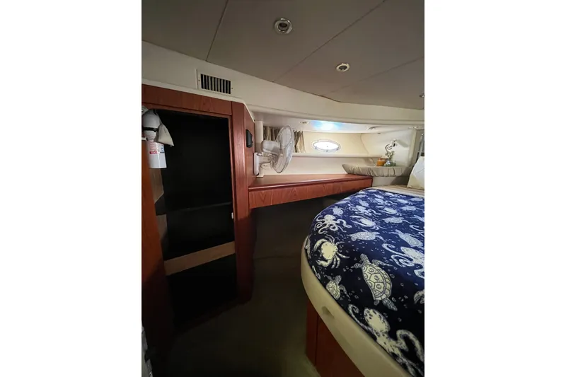 Slide: The Image of Cozy cabin interior of 1999 Maxum 4600 SCB yacht with nautical-themed bedding. - 21