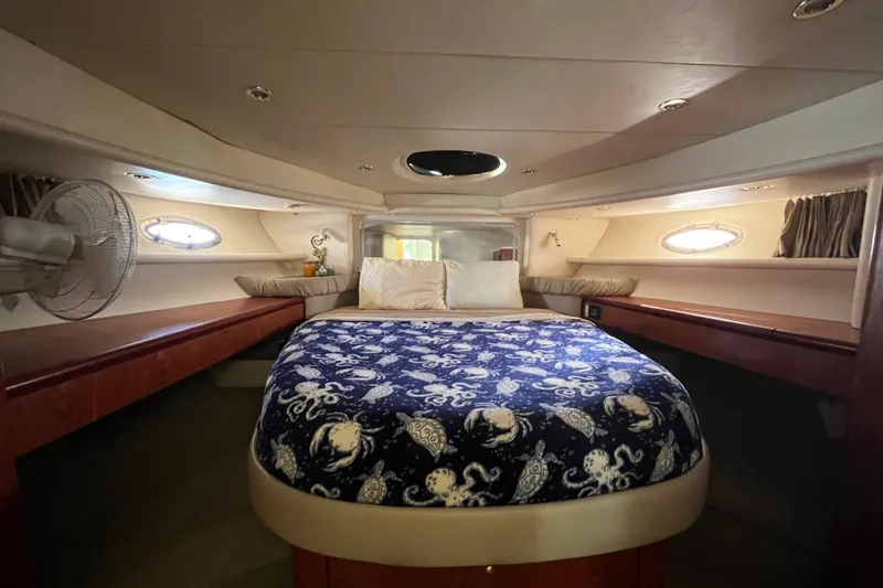 Slide: The Image of Luxurious cabin interior of a 1999 Maxum 4600 SCB yacht with nautical-themed bedding. - 19