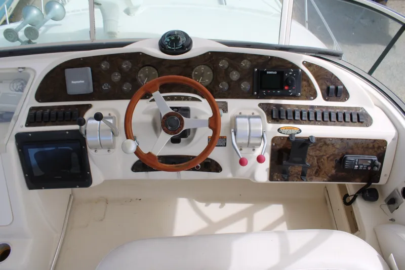Slide: The Image of 1999 Maxum 4600 SCB yacht helm with wooden steering wheel and control panel. - 29