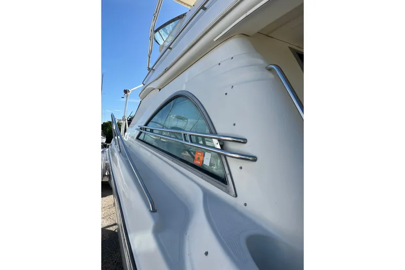 Slide: The Image of 1999 Maxum 4600 SCB yacht side view with sleek design and chrome accents. - 33