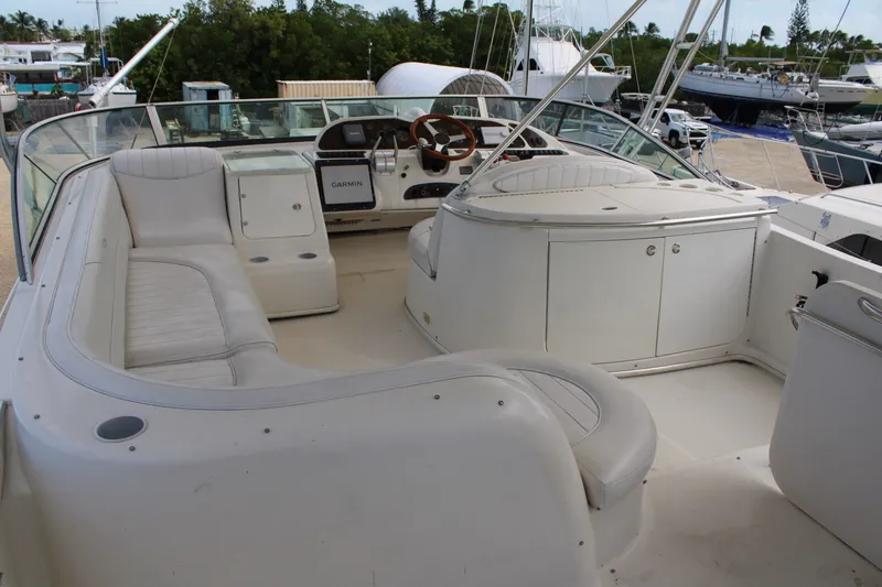 Slide: The Image of 1999 Maxum 4600 SCB yacht interior with white seating and Garmin navigation system. - 25