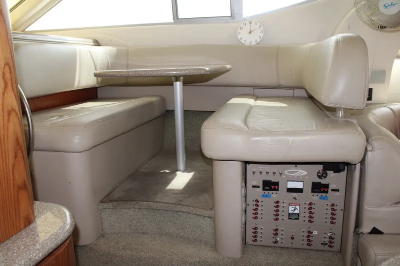 Slide: The Image of Interior of 1999 Maxum 4600 SCB yacht with beige seating and control panel. - 12