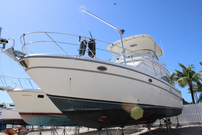 Slide: The Image of 1999 Maxum 4600 SCB yacht on stands, clear sky background. - 2