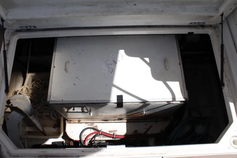 Slide: The Image of Storage compartment of a 1999 Maxum 4600 SCB boat, featuring ropes and equipment. - 34