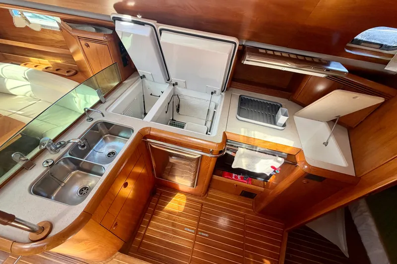 Slide: The Image of Luxurious 2008 Jeanneau Sun Odyssey 49 DS yacht kitchen with double sink and wooden cabinetry. - 58