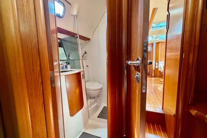 Slide: The Image of Interior of 2008 Jeanneau Sun Odyssey 49 DS yacht, featuring a wooden bathroom and cabin. - 82
