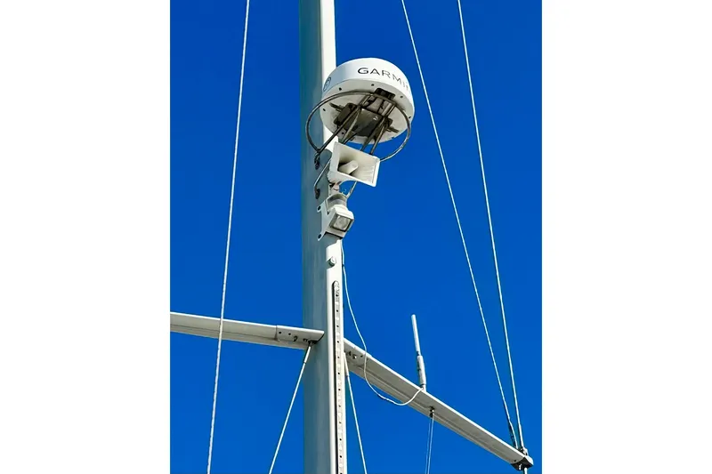 Slide: The Image of Mast of 2008 Jeanneau Sun Odyssey 49 DS sailboat with radar equipment against blue sky. - 17