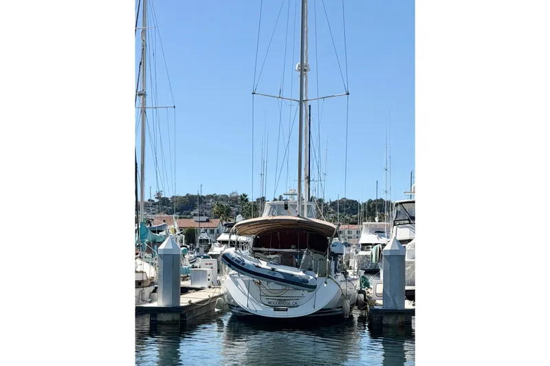 Slide: The Image of 2008 Jeanneau Sun Odyssey 49 DS sailboat docked in a marina under clear blue skies. - 38