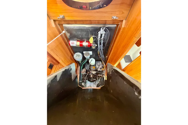 Slide: The Image of Engine compartment of 2008 Jeanneau Sun Odyssey 49 DS sailboat, featuring fire extinguisher and hoses. - 63