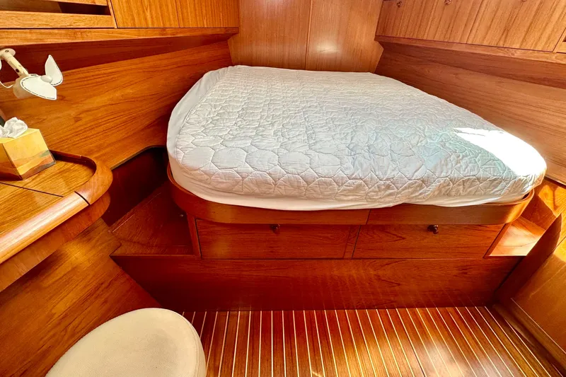 Slide: The Image of Cozy cabin interior of 2008 Jeanneau Sun Odyssey 49 DS with wooden finish and bed. - 65