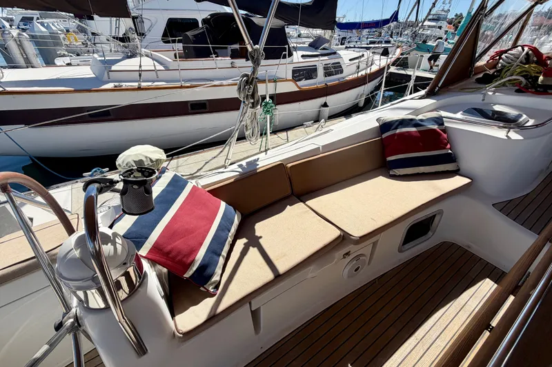 Slide: The Image of 2008 Jeanneau Sun Odyssey 49 DS yacht deck with cushioned seating and nautical pillows. - 24