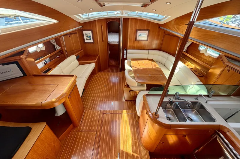 Slide: The Image of Luxurious interior of 2008 Jeanneau Sun Odyssey 49 DS yacht with wood finish and seating area. - 40