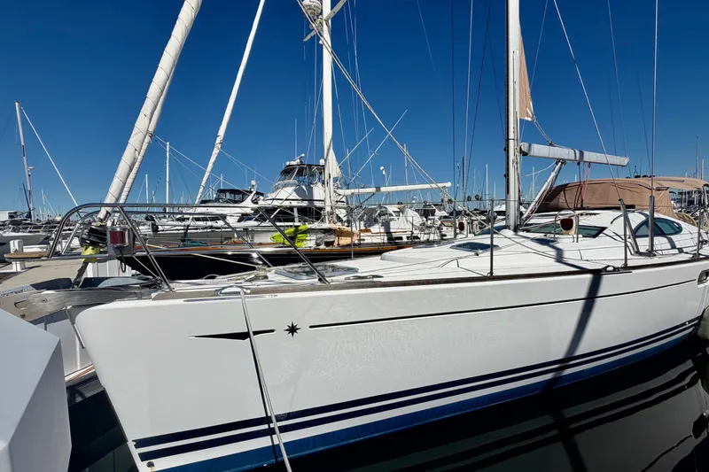 Slide: The Image of 2008 Jeanneau Sun Odyssey 49 DS sailboat docked at marina under clear blue sky. - 7