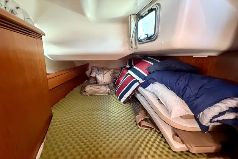 Slide: The Image of Cozy cabin interior of 2008 Jeanneau Sun Odyssey 49 DS with bedding and window. - 76