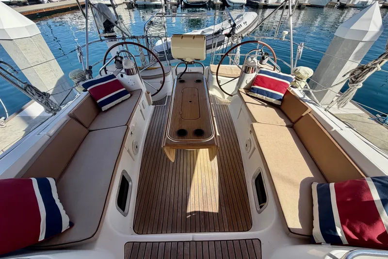 Slide: The Image of Cockpit of 2008 Jeanneau Sun Odyssey 49 DS with cushioned seating and nautical decor. - 27