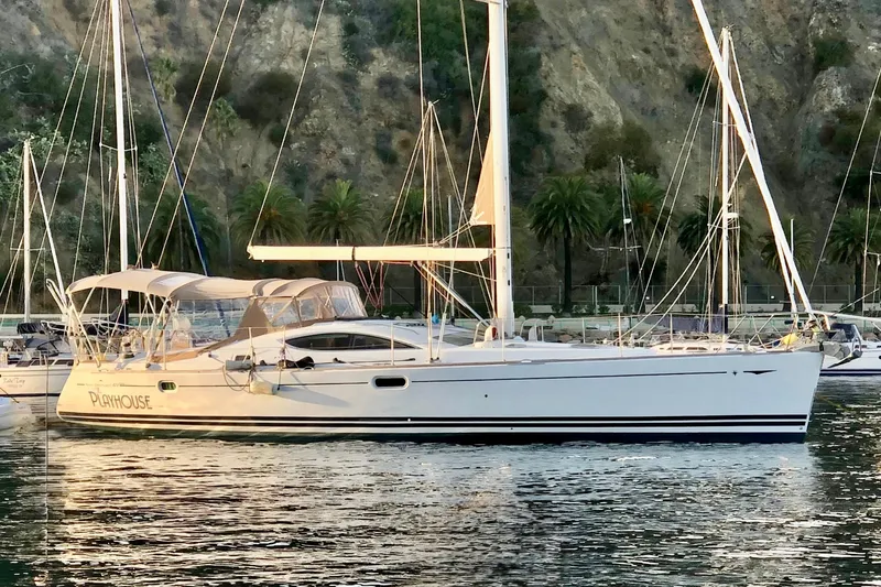 Slide: The Image of 2008 Jeanneau Sun Odyssey 49 DS sailboat docked in a scenic marina setting. - 2