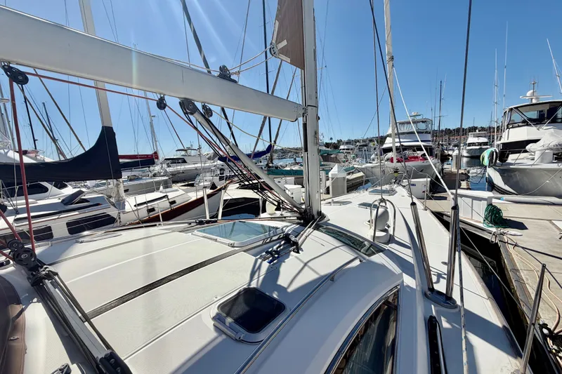 Slide: The Image of 2008 Jeanneau Sun Odyssey 49 DS sailboat docked in a marina under clear blue skies. - 13