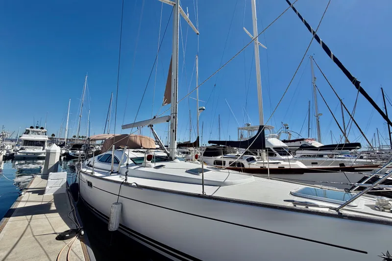 Slide: The Image of 2008 Jeanneau Sun Odyssey 49 DS sailboat docked in a marina under clear blue skies. - 4