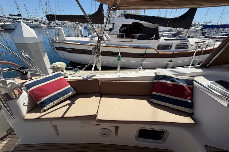 Slide: The Image of Cozy seating area on 2008 Jeanneau Sun Odyssey 49 DS sailboat, docked at marina. - 26