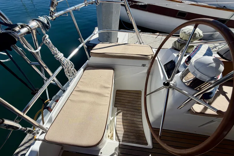 Slide: The Image of Cockpit of 2008 Jeanneau Sun Odyssey 49 DS sailboat with wooden deck and steering wheel. - 23