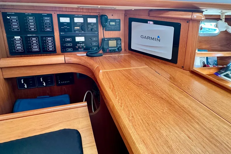 Slide: The Image of Navigation station of 2008 Jeanneau Sun Odyssey 49 DS with Garmin display and control panels. - 46