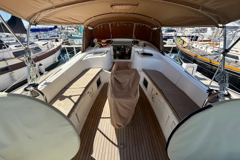 Slide: The Image of Spacious cockpit of 2008 Jeanneau Sun Odyssey 49 DS yacht, featuring comfortable seating and canopy. - 29