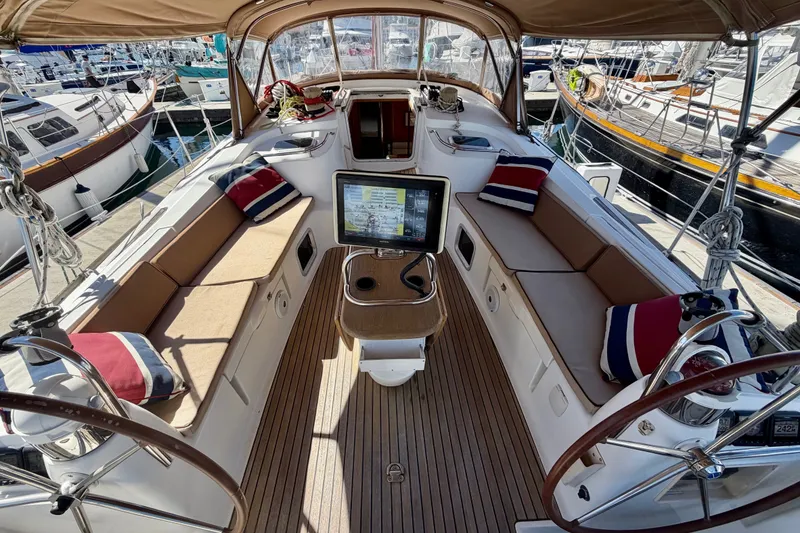 Slide: The Image of Cockpit of 2008 Jeanneau Sun Odyssey 49 DS sailboat with seating and navigation equipment. - 18