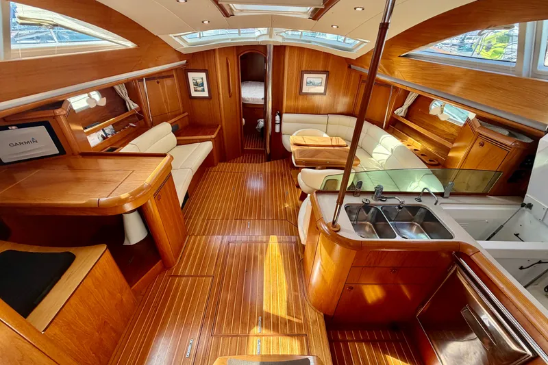 Slide: The Image of Luxurious interior of 2008 Jeanneau Sun Odyssey 49 DS yacht with wood finish and seating area. - 39