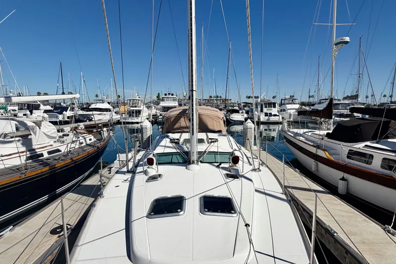 Slide: The Image of 2008 Jeanneau Sun Odyssey 49 DS sailboat docked in a busy marina under clear blue skies. - 16
