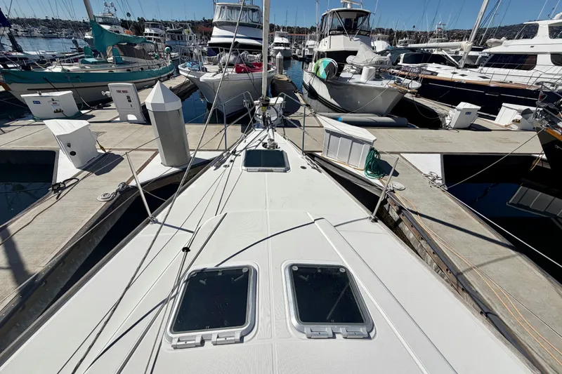 Slide: The Image of 2008 Jeanneau Sun Odyssey 49 DS sailboat docked at marina, surrounded by other boats. - 14