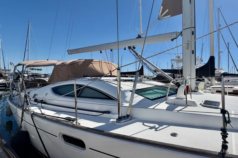 Slide: The Image of 2008 Jeanneau Sun Odyssey 49 DS sailboat docked in a marina under clear blue skies. - 5