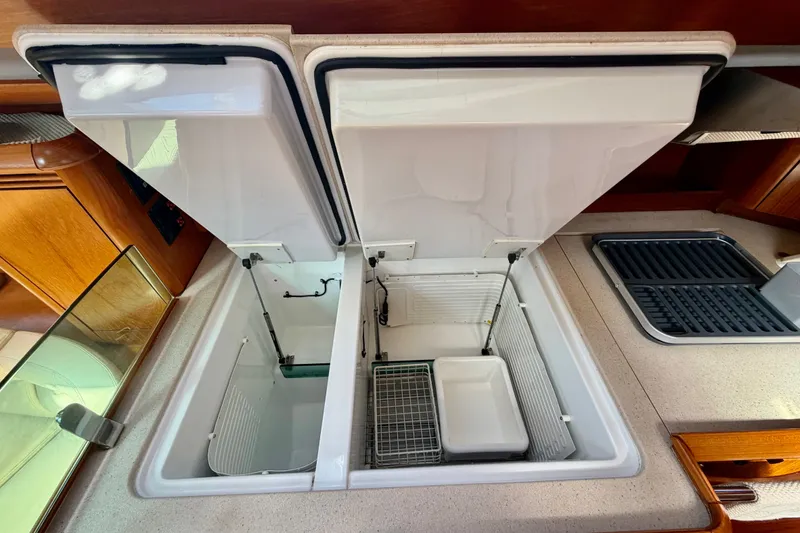 Slide: The Image of Open refrigerator compartments in 2008 Jeanneau Sun Odyssey 49 DS yacht kitchen. - 59
