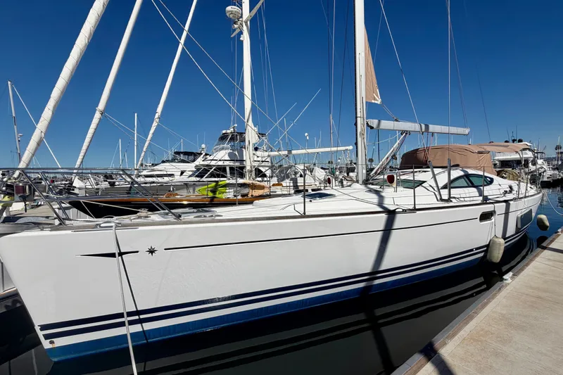 Slide: The Image of 2008 Jeanneau Sun Odyssey 49 DS sailboat docked at marina under clear blue sky. - 8