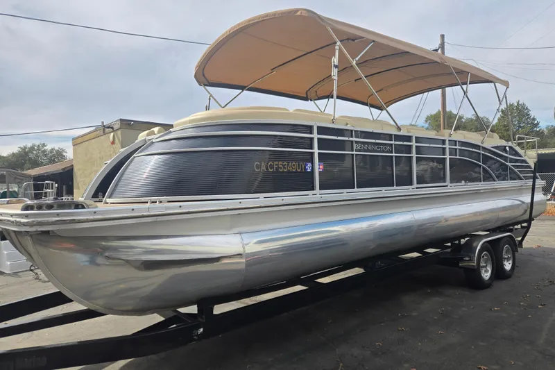 Slide: The Image of 2014 Bennington 2875 QCW I/O pontoon boat with canopy on trailer. - 1