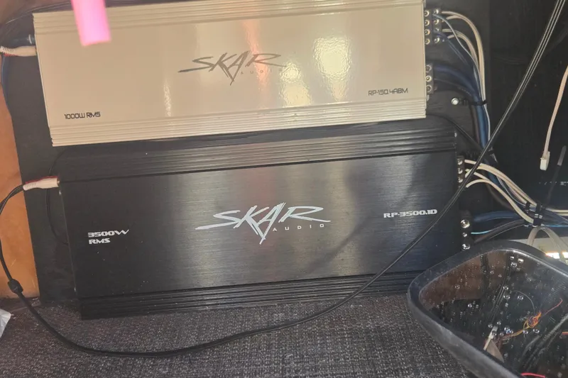 Slide: The Image of Skar Audio amplifiers installed in a 2014 Bennington 2875 QCW I/O boat. - 3