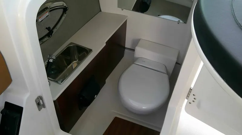 Slide: The Image of Interior of a modern boat cabin with a toilet, sink, and mirror. - 18